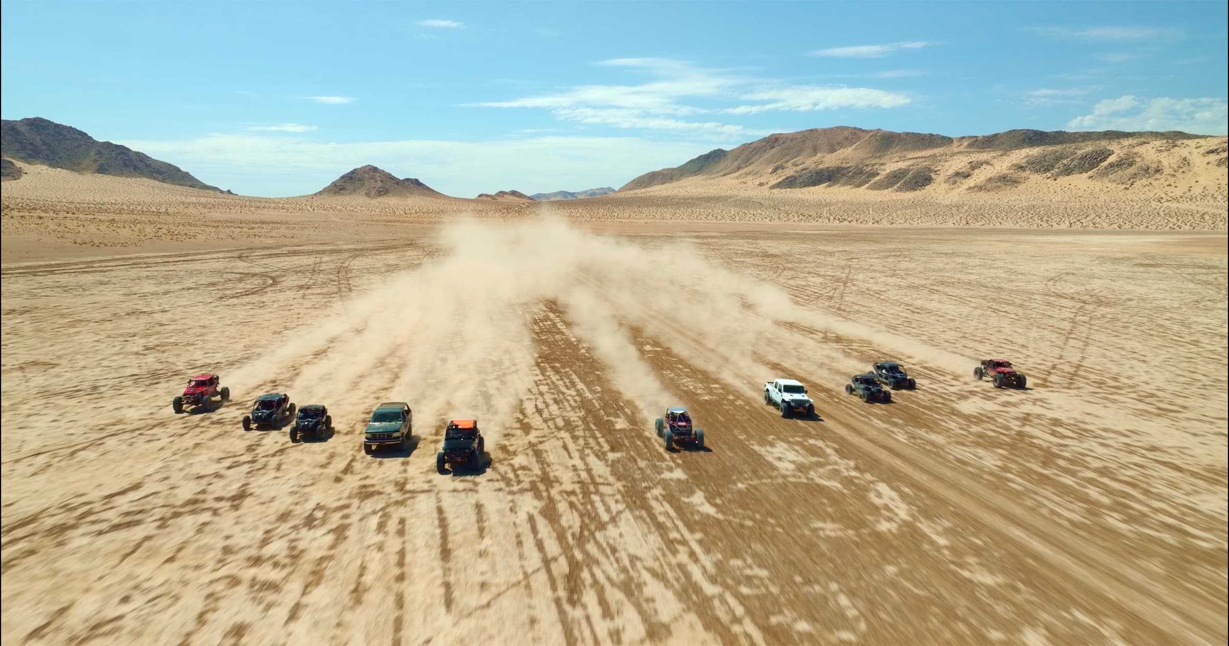 Off-road rigs fanned out across the open desert lakebed